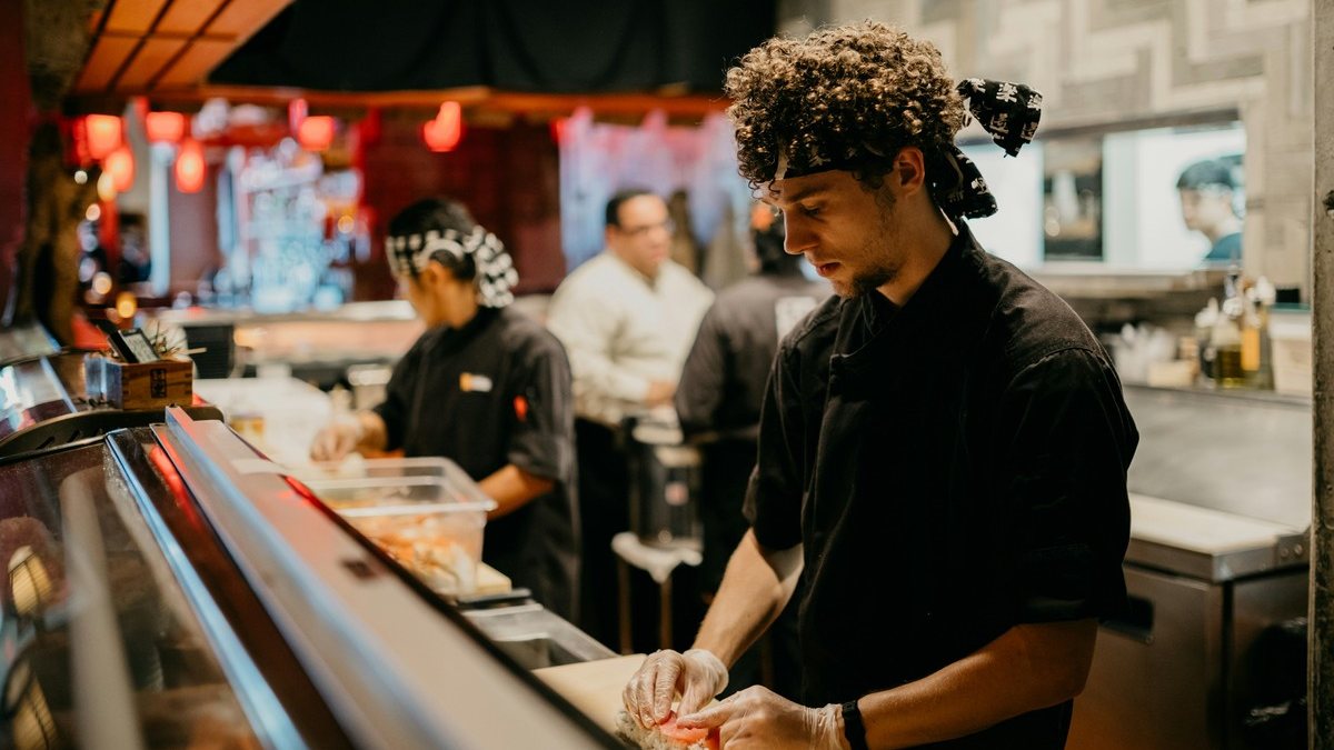 Restaurant employees preparing food in a commercial kitchen