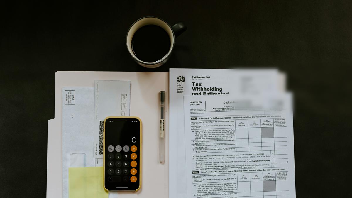 Tax documents and calculator on an accountant's desk